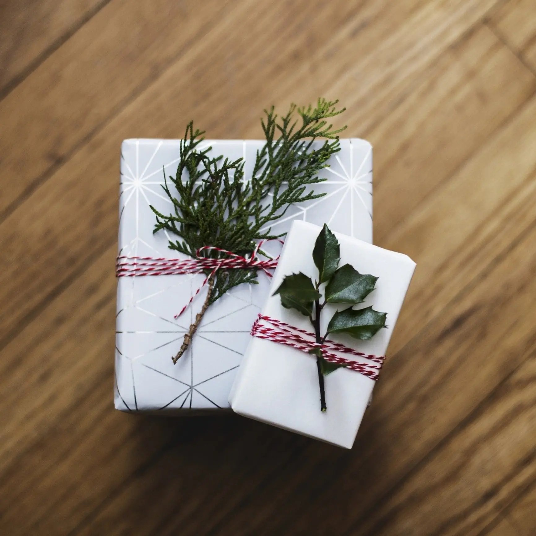 white gift boxes with sprig plant garlands
