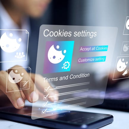 Man typing on computer screen with cookie settings typed onto the screen with blue and purple cookie icons