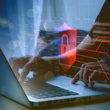 man typing on laptop with an overlay of network of red lines with a red shield with a lock