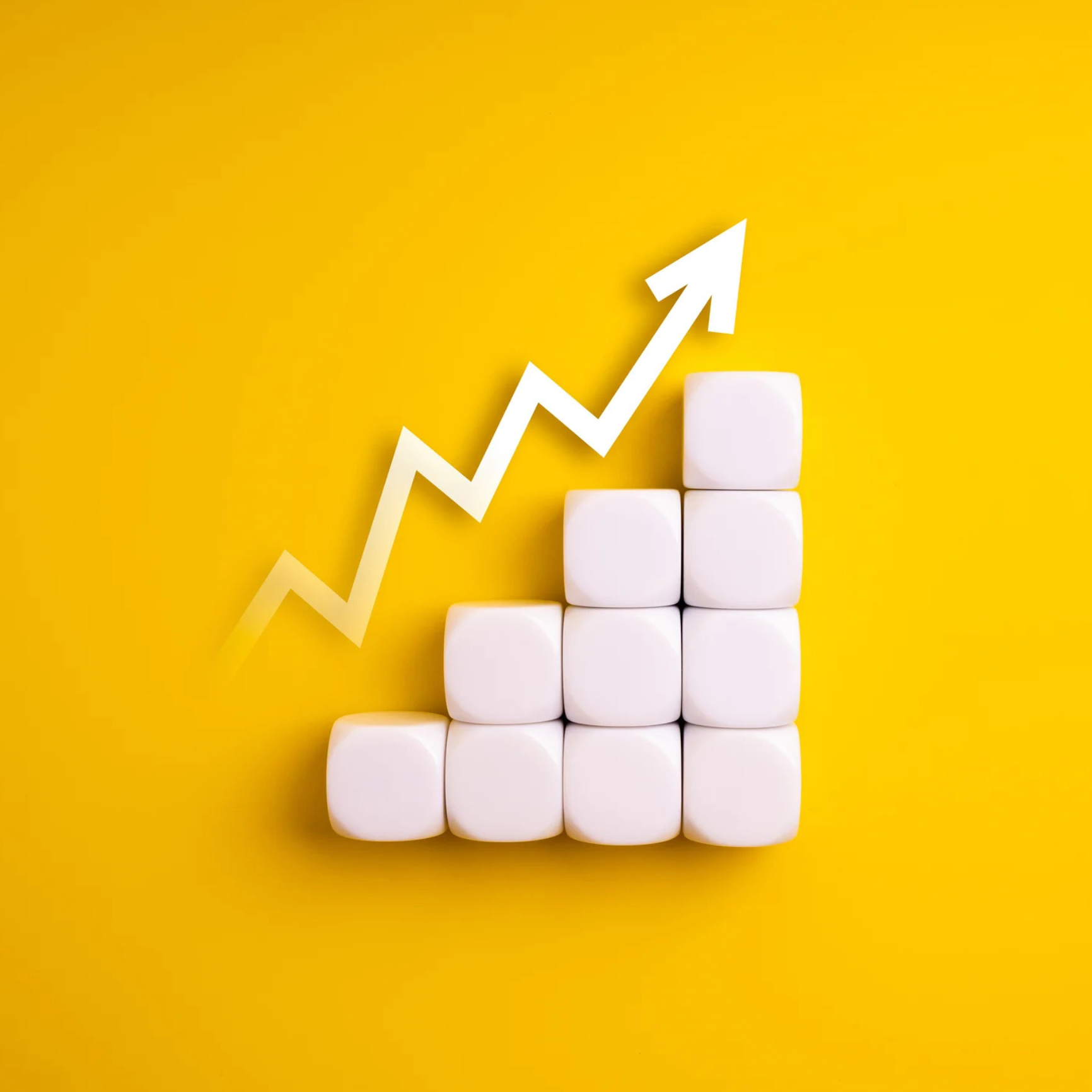 Stack of white blocks in an upward height with an increasing zigzag arrow o n a yellow background