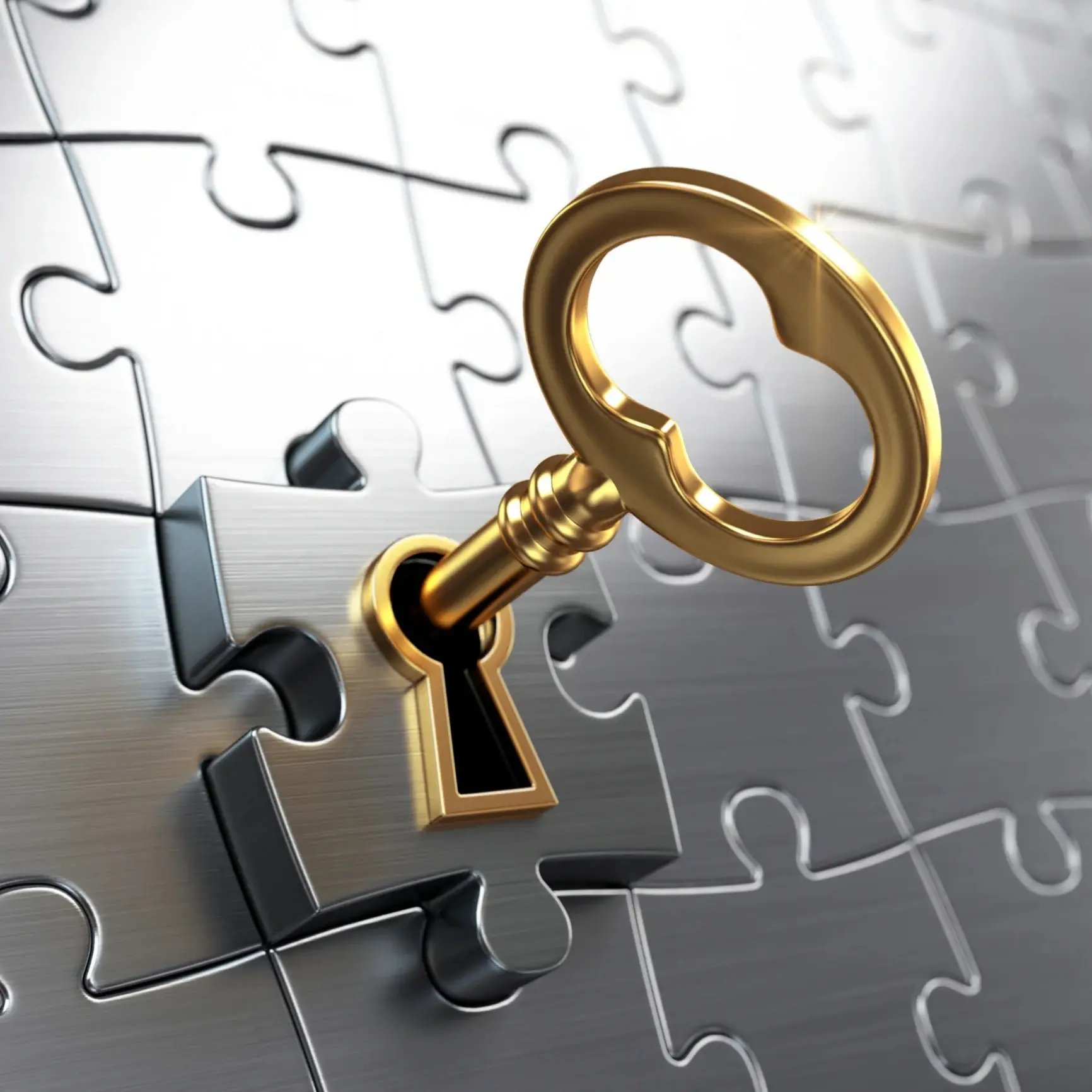 Gold key in silver puzzle piece lock
