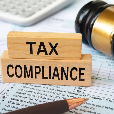 Tax compliance block and gavel and pen