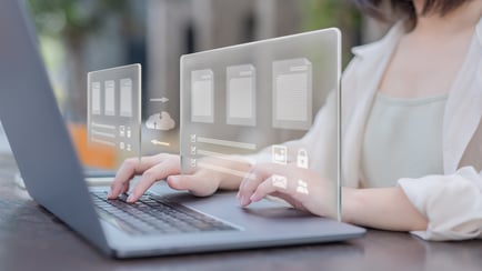 Hands typing on a laptop with digital icons representing platform migration and data transfer.