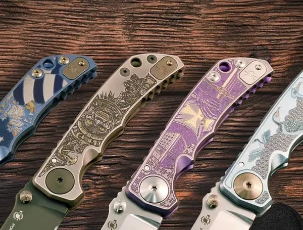 Four intricately designed Wicked Grips folding knives are displayed on a wooden surface. Each knife handle features unique patterns and colors, evoking a sense of artistry and precision