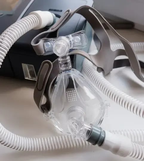 CPAP mask with tubing connected to sleep apnea machine, close-up of respiratory therapy equipment for home breathing support and oxygen therapy